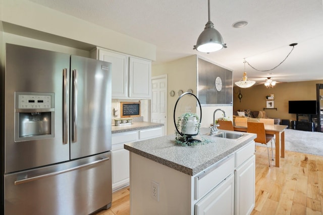 3998 Kul Cir S, Hilliard, OH 43026 - kitchen featuring light wood finished floors, a sink, stainless steel refrigerator with ice dispenser, and white cabinets