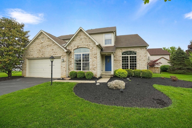 3998 Kul Cir S, Hilliard, OH 43026 - french country inspired facade with aphalt driveway, an attached garage, brick siding, and a front yard