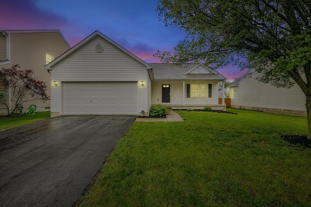 5933 Katara Dr, Galloway, OH 43119 - view of front of home featuring asphalt driveway, an attached garage, a front yard, and a shingled roof