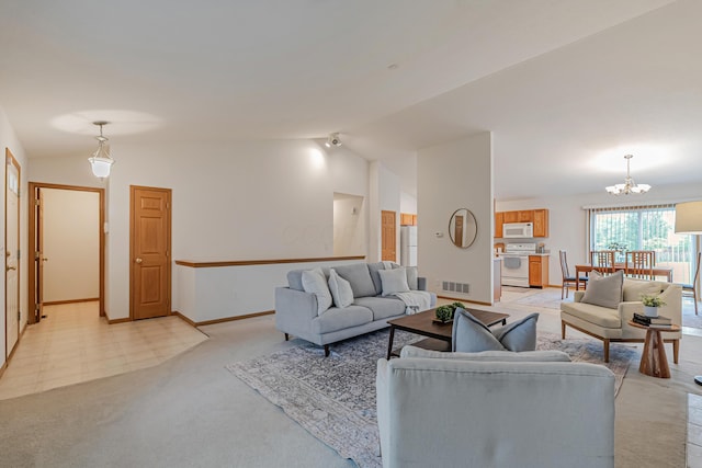 5933 Katara Dr, Galloway, OH 43119 - living area featuring lofted ceiling, a chandelier, light carpet, and baseboards
