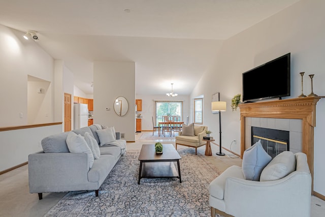 5933 Katara Dr, Galloway, OH 43119 - living room with lofted ceiling, baseboards, a chandelier, and light colored carpet