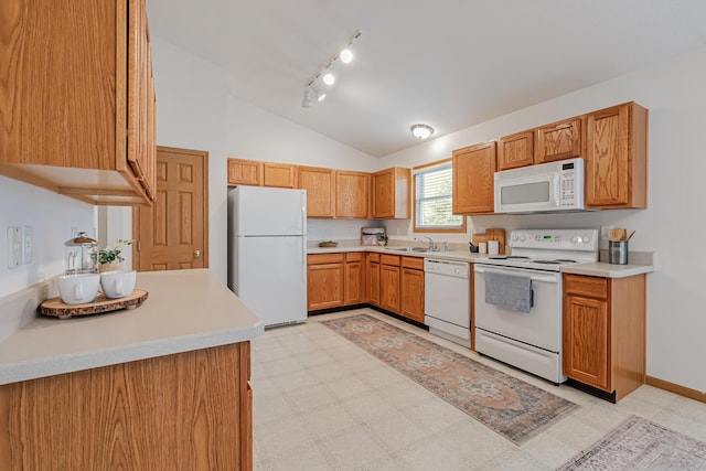 5933 Katara Dr, Galloway, OH 43119 - kitchen featuring white appliances, a sink, lofted ceiling, rail lighting, and light countertops