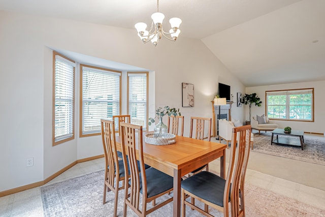 5933 Katara Dr, Galloway, OH 43119 - dining space featuring a chandelier, a fireplace, vaulted ceiling, and baseboards