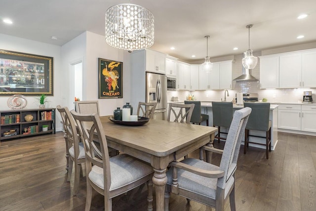 dining space featuring a notable chandelier, recessed lighting, and dark wood-style floors