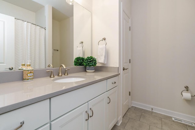full bathroom with baseboards, tile patterned floors, vanity, and visible vents