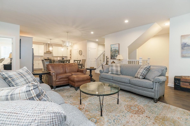 living area with baseboards, stairway, recessed lighting, and wood finished floors