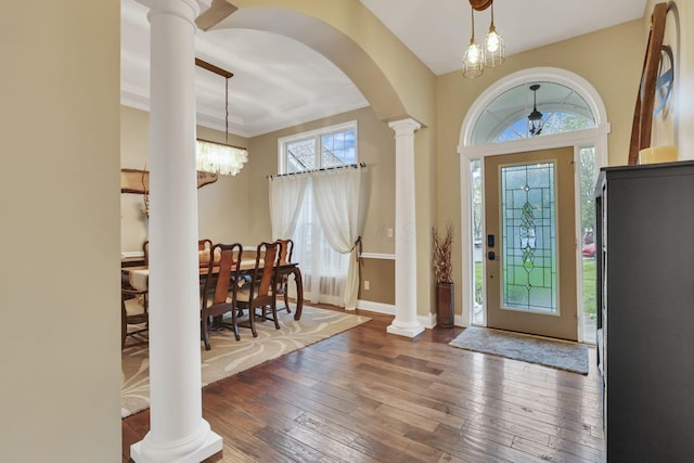 4650 Commons Park Dr, New Albany, OH 43054 - entryway with hardwood / wood-style flooring, decorative columns, arched walkways, baseboards, and a chandelier