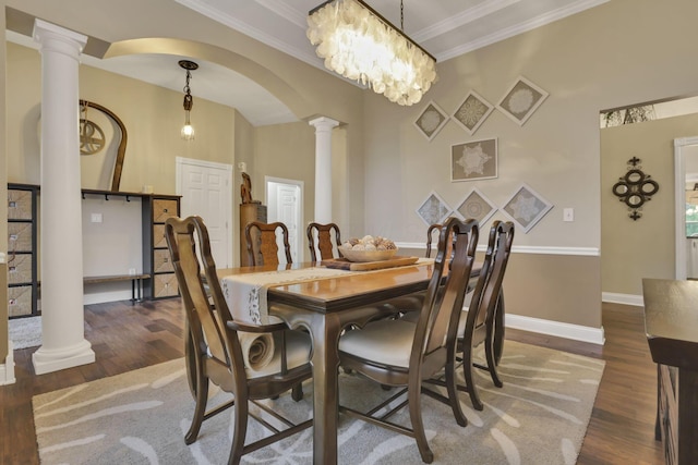 4650 Commons Park Dr, New Albany, OH 43054 - dining space featuring decorative columns, wood finished floors, crown molding, arched walkways, and baseboards