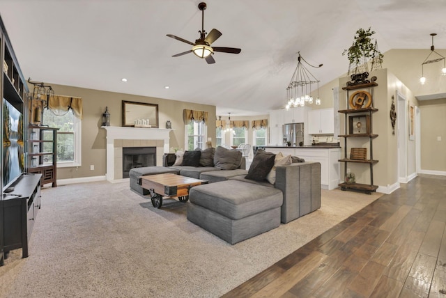 4650 Commons Park Dr, New Albany, OH 43054 - living room with baseboards, wood finished floors, a tile fireplace, a ceiling fan, and plenty of natural light