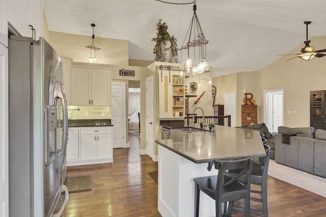 4650 Commons Park Dr, New Albany, OH 43054 - kitchen featuring stainless steel fridge with ice dispenser, a sink, open floor plan, dark countertops, and high vaulted ceiling