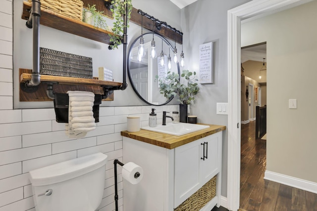 4650 Commons Park Dr, New Albany, OH 43054 - half bathroom with toilet, vanity, wood finished floors, and tile walls
