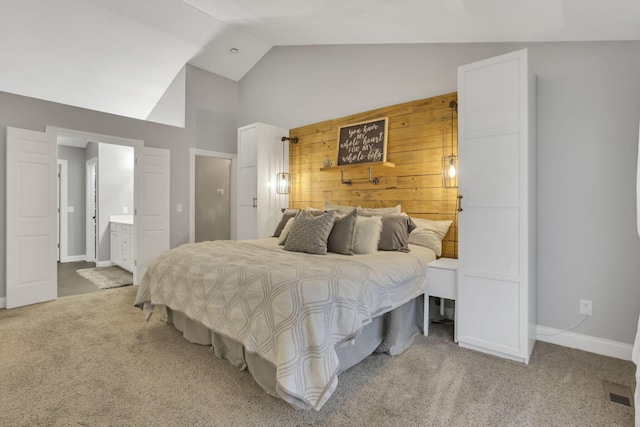 4650 Commons Park Dr, New Albany, OH 43054 - carpeted bedroom featuring high vaulted ceiling, ensuite bathroom, and baseboards