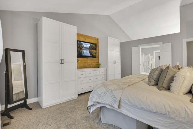 4650 Commons Park Dr, New Albany, OH 43054 - bedroom with lofted ceiling, light colored carpet, ensuite bathroom, and baseboards