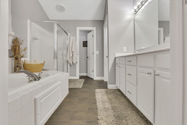 4650 Commons Park Dr, New Albany, OH 43054 - bathroom with a shower stall, vanity, a garden tub, and baseboards