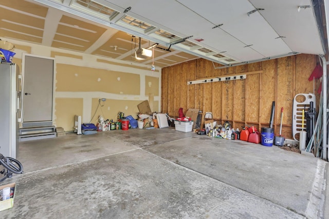 4650 Commons Park Dr, New Albany, OH 43054 - garage featuring a garage door opener and freestanding refrigerator