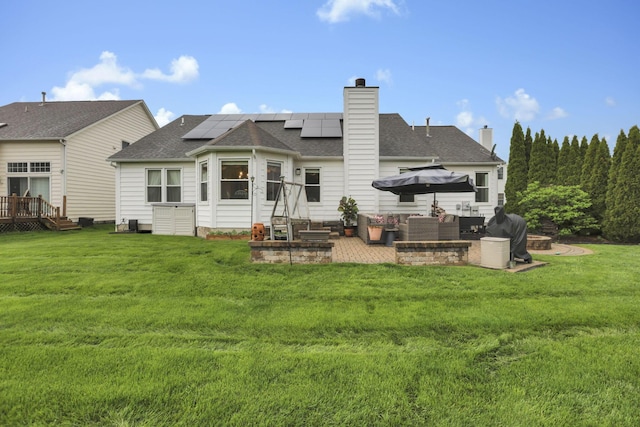 4650 Commons Park Dr, New Albany, OH 43054 - back of house with an outdoor living space, solar panels, a yard, a chimney, and a patio area