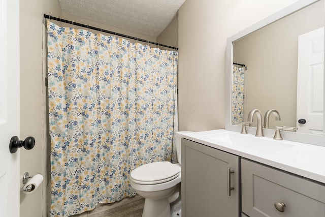 1409 Hackworth St, Columbus, OH 43207 - bathroom with a textured ceiling, vanity, wood finished floors, toilet, and a shower with curtain
