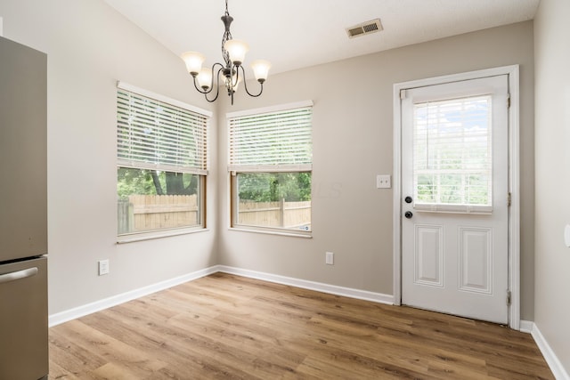 1409 Hackworth St, Columbus, OH 43207 - unfurnished dining area featuring a chandelier, wood finished floors, and baseboards
