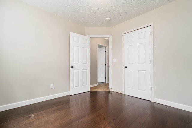 1409 Hackworth St, Columbus, OH 43207 - unfurnished bedroom featuring wood finished floors, baseboards, and a textured ceiling