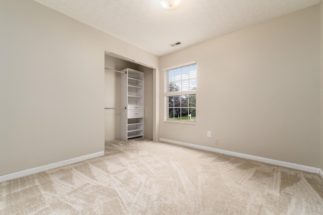 1409 Hackworth St, Columbus, OH 43207 - unfurnished bedroom with carpet floors, baseboards, a textured ceiling, and a closet