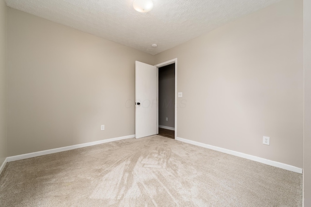 1409 Hackworth St, Columbus, OH 43207 - spare room with light carpet, a textured ceiling, and baseboards