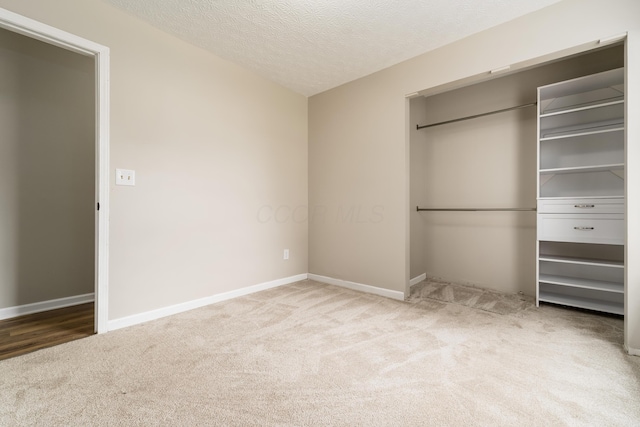 1409 Hackworth St, Columbus, OH 43207 - unfurnished bedroom with carpet flooring, a closet, a textured ceiling, and baseboards