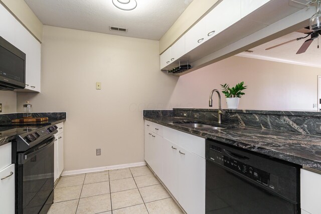 kitchen with a sink, dark stone counters, black appliances, a ceiling fan, and white cabinets