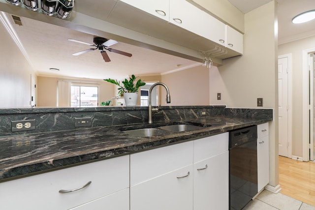 kitchen with a sink, dark stone countertops, dishwasher, crown molding, and white cabinets