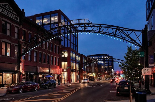 view of road with street lights, curbs, and sidewalks