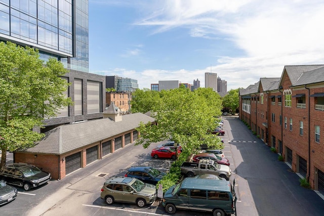 exterior space with community garages and uncovered parking