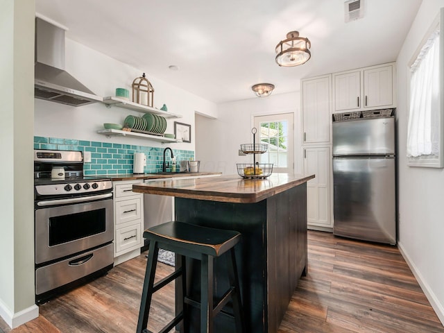 5349 Norwich St, Hilliard, OH 43026 - kitchen with stainless steel appliances, butcher block counters, wall chimney exhaust hood, white cabinets, and dark wood-style floors