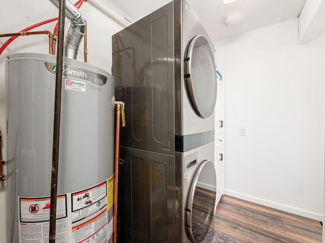 5349 Norwich St, Hilliard, OH 43026 - washroom with water heater, stacked washer / dryer, wood finished floors, and baseboards