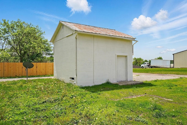 view of outbuilding with an outdoor structure and fence