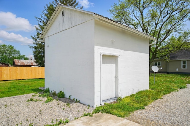 view of outdoor structure with an outbuilding and fence
