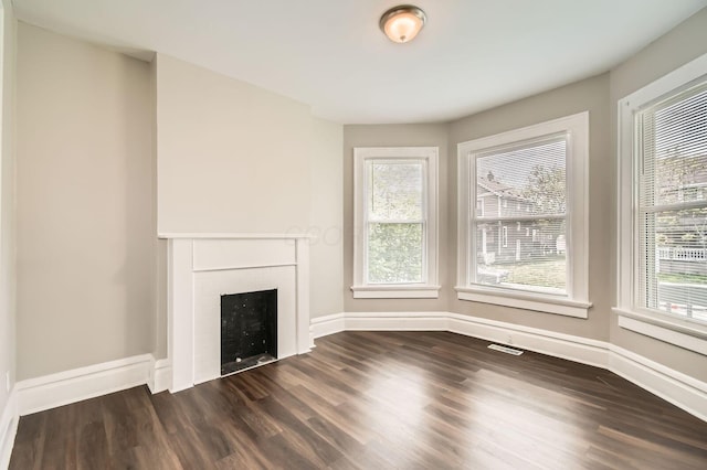 96 S Eureka Ave, Columbus, OH 43204 - unfurnished living room with dark wood-style floors and plenty of natural light