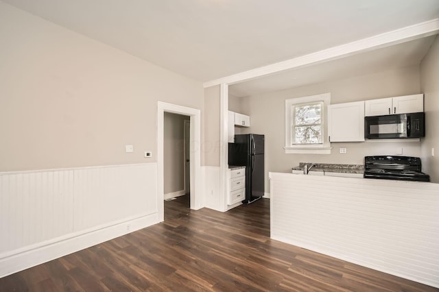 96 S Eureka Ave, Columbus, OH 43204 - kitchen with black appliances, white cabinetry, a wainscoted wall, and dark wood-style flooring
