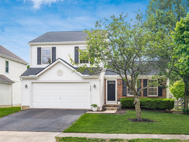 2284 Brisum Way, Hilliard, OH 43026 - traditional-style house featuring asphalt driveway, a front lawn, an attached garage, and a shingled roof