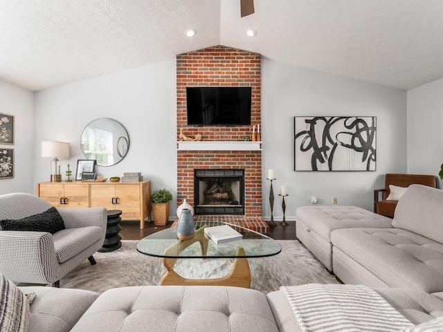 2284 Brisum Way, Hilliard, OH 43026 - living area featuring lofted ceiling, wood finished floors, a fireplace, a textured ceiling, and recessed lighting