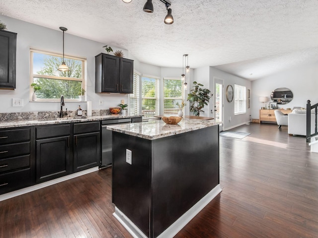 2284 Brisum Way, Hilliard, OH 43026 - kitchen with stainless steel dishwasher, a sink, a kitchen island, dark wood finished floors, and dark cabinets