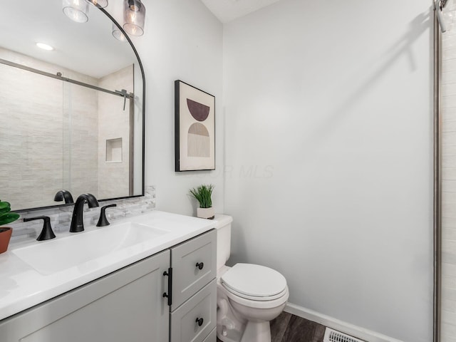 2284 Brisum Way, Hilliard, OH 43026 - bathroom with toilet, wood finished floors, a stall shower, vanity, and baseboards