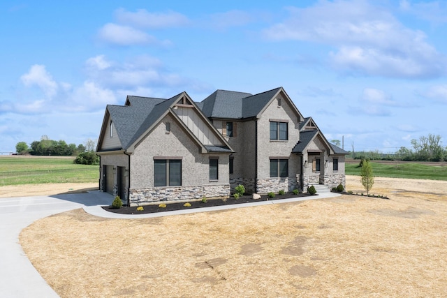 craftsman-style house with concrete driveway, stone siding, and an attached garage