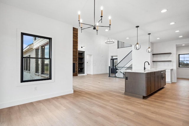 kitchen featuring recessed lighting, modern cabinets, an inviting chandelier, open shelves, and light countertops