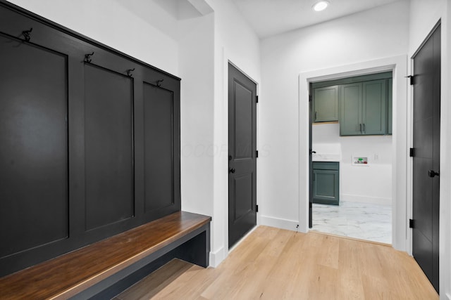 mudroom featuring light wood finished floors, baseboards, and recessed lighting