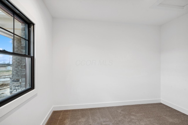 carpeted empty room with baseboards