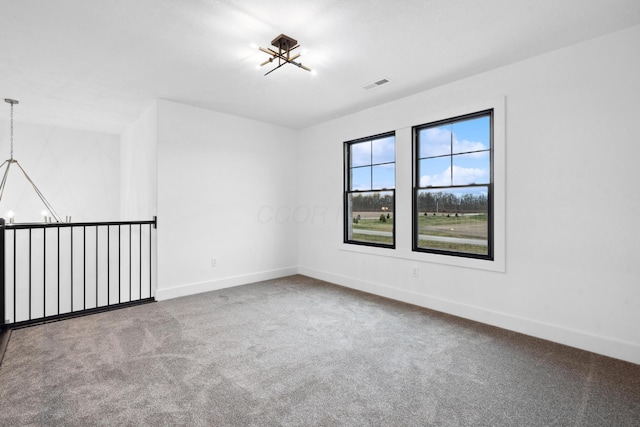 unfurnished room featuring carpet flooring, baseboards, and visible vents