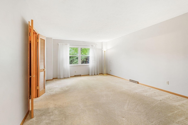 unfurnished room featuring baseboards and carpet flooring