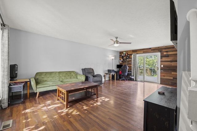 1301 Della Pl, Columbus, OH 43228 - living room featuring ceiling fan, wood walls, wood finished floors, and a desk