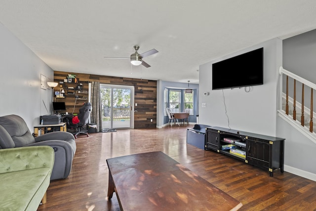1301 Della Pl, Columbus, OH 43228 - living room featuring wood finished floors, ceiling fan, stairs, wood walls, and baseboards