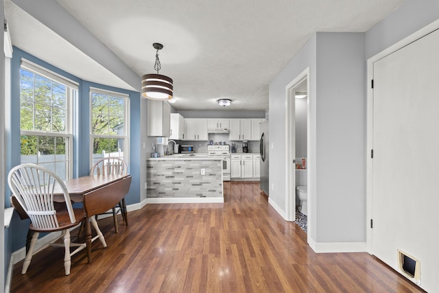 1301 Della Pl, Columbus, OH 43228 - kitchen with stainless steel fridge, white range with electric stovetop, baseboards, white cabinetry, and dark wood-style floors