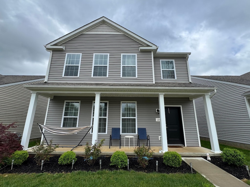 traditional-style home featuring covered porch